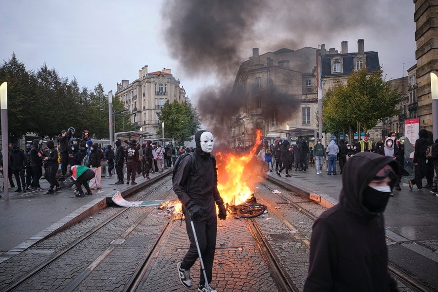 Protesters gather around a burning barricade during a demonstration against the rising cost of living and cuts to public services in Bordeaux, France, on October 24, 2026. Photo: Guillaume Pinon/EPA via ANA-MPA.