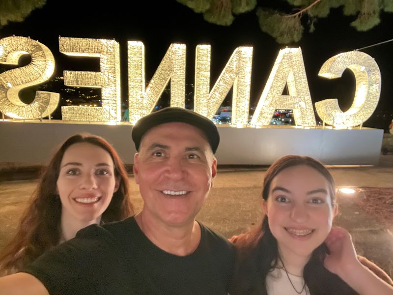 Greek American film and television producer James P. Axiotis, center, poses with his daughters in Cannes, France. Photo: James P. Axiotis/LinkedIn.