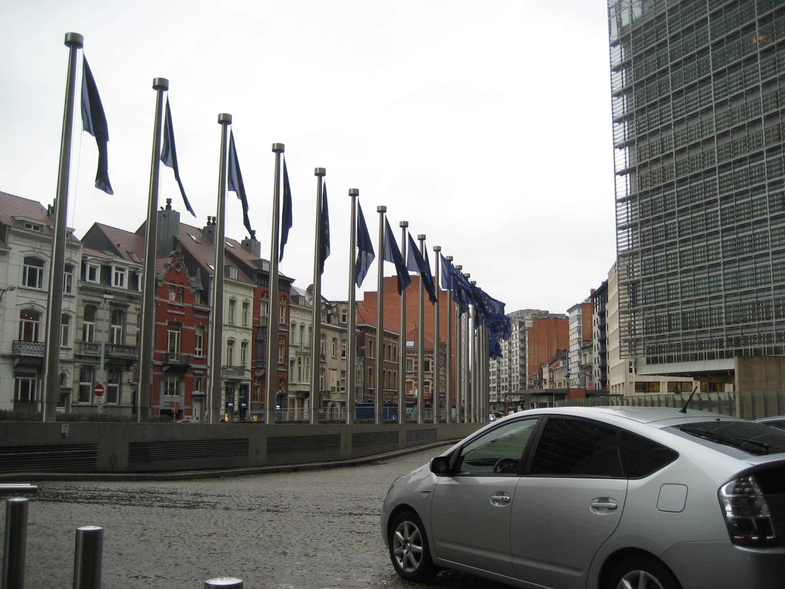 European Union flags flying outside the Berlaymont building.